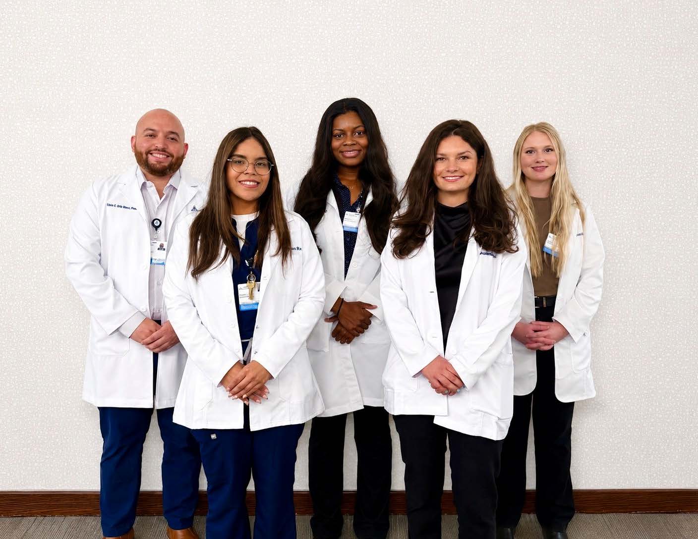 Group photo of 5 pharmacy residents in lab coast from Ascension Saint Thomas pharmacy residency program West for 26-27 year